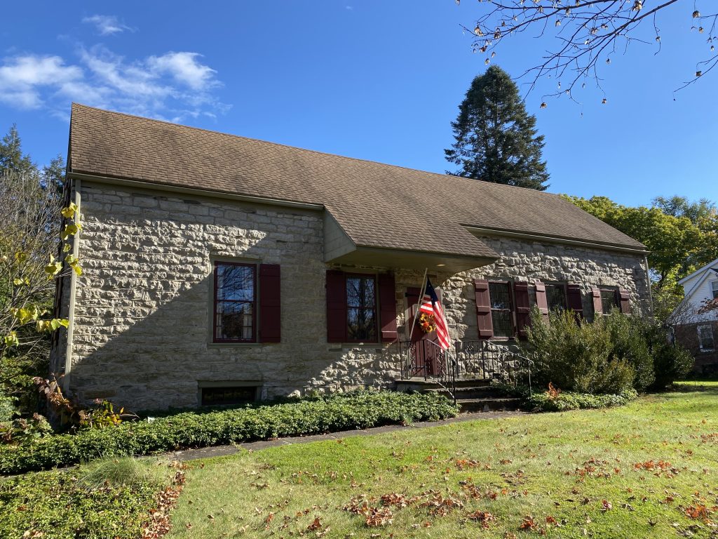 A front side of an historic stone house.